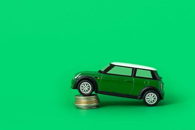 Coche de juguete con monedas. Gastos y préstamos para el mantenimiento del transporte. Gasolina, alquiler de vehículos y precios de reparación.