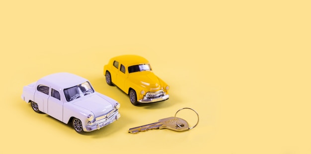 Coches de juguete blancos y amarillos aislados sobre fondo amarillo