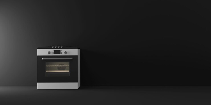 Cocina de gas moderna cerca de la pared sobre fondo negro de estudio