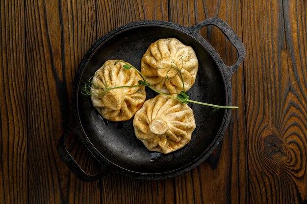 Cocina georgiana Hinkali en platos sobre una mesa de madera