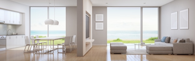 Cocina con vistas al mar, comedor y sala de estar de la casa de playa de lujo en un diseño moderno.