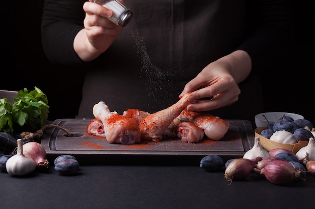 Una cocinera prepara un pollo.