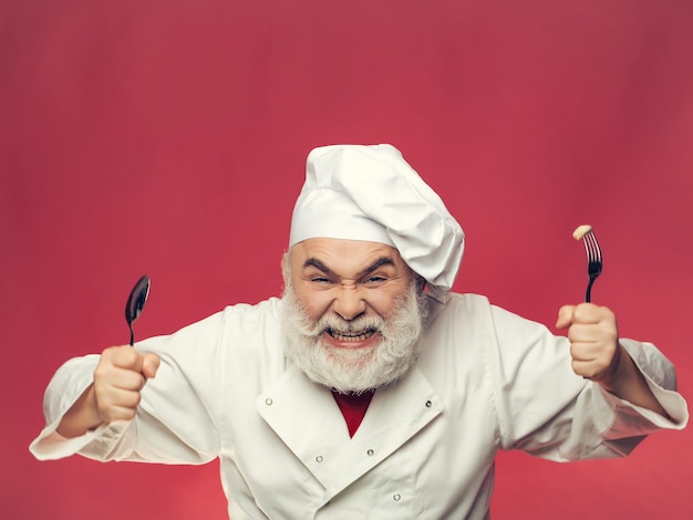 Cocinero barbudo con cuchara y tenedor