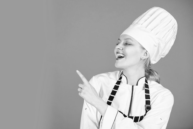 Cocinero feliz señalando con el dedo la preparación de la cena en casa cocinar es mi espacio de copia de hobby Retrato de chef femenina Premio de cocina Chef profesional mujer lista para comer vamos a cocinar