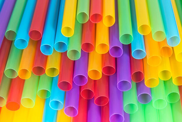 Cocktail-Kunststoffröhren in verschiedenen Farben schließen abstrakten Hintergrund und Texturen