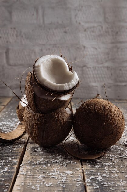 Coco e leite coco quebrado em fundo de tábuas de madeira