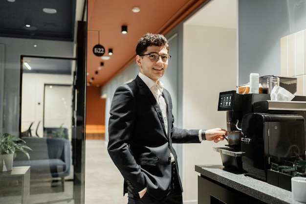 Coffee break un gerente con anteojos un hombre con ropa formal trabaja en una oficina en un coworking