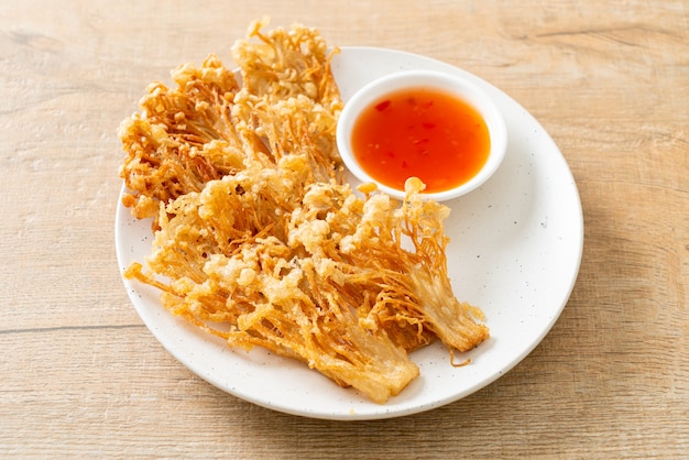cogumelo enoki frito ou cogumelo de agulha dourada com molho picante - estilo de comida vegana