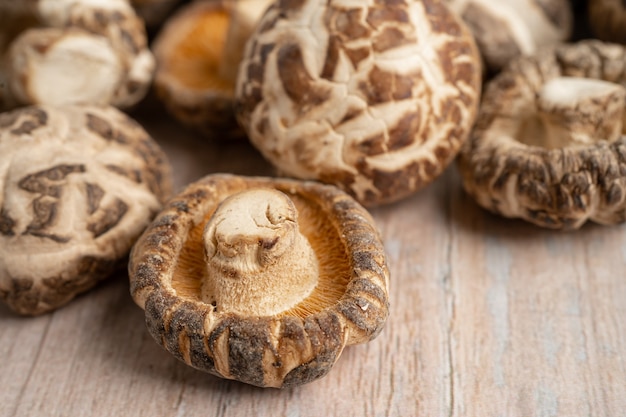 Foto cogumelo shiitake seco em fundo de madeira. comida saudável.