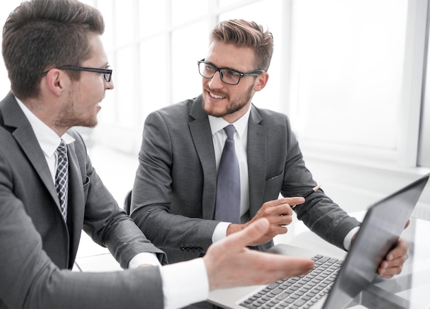 Colegas de negócios próximos discutem algo sentado na mesa