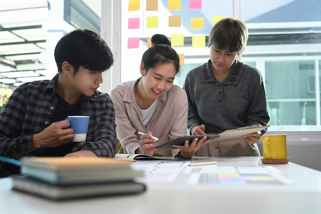 Colegas de trabalho em equipe de inicialização e compartilhamento de ideias na moderna sala de reuniões.