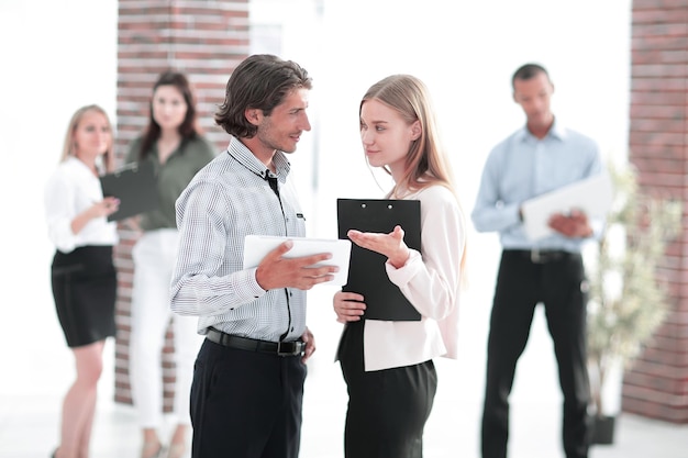 Colegas de negocios hablando de pie en una oficina moderna