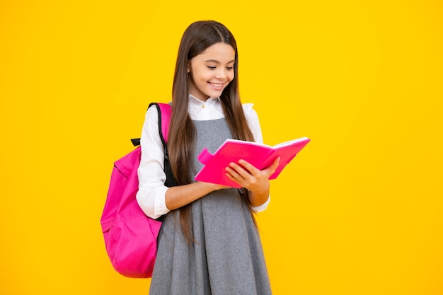 Colegiala adolescente estudiante chica mantenga libro sobre fondo amarillo estudio aislado Concepto de escuela y educación Regreso a la escuela