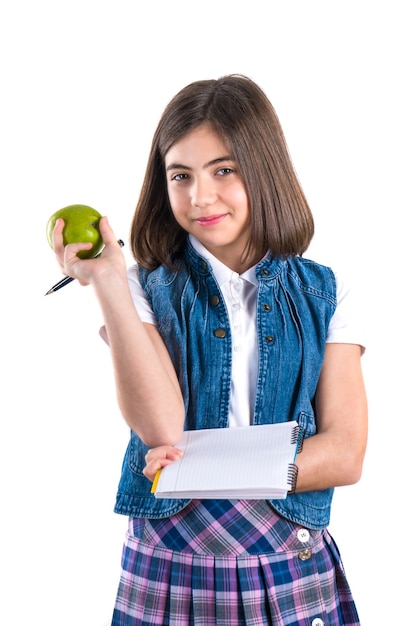 Colegiala con cuaderno y manzana en blanco