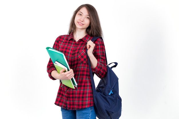 Colegiala hermosa chica, estudiante con libros de texto y mochila