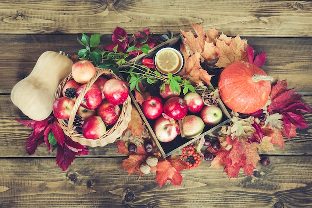 Colheita de outono, abóbora, maçãs na cesta, folhas de outono.