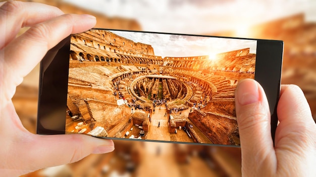 Coliseu ou Coliseu no verão Roma Itália Turista tirando foto dentro do famoso Coliseu por telefone celular