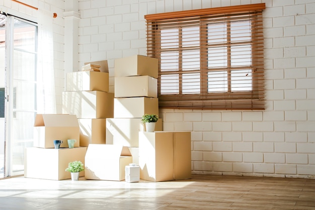 Se colocaron muchas cajas grandes de papel marrón en la entrada de la casa. Conceptos de reubicación. copia espacio