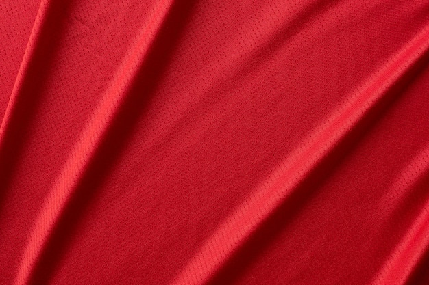 Color rojo de la vista superior de la textura de la textura de la camiseta del fútbol de la tela de los deportes