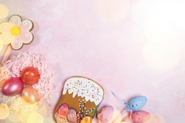 Coloração de ovos de Páscoa pães de gengibre e sobreposição de bokeh em rosa top view espaço de cópia