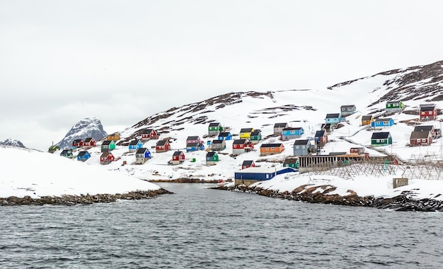 Coloridas casas de pueblo pesquero ártico en el fiordo rocoso en medio de la nada Kangamiut Groenlandia