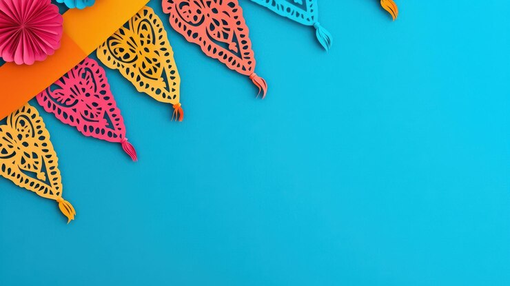 Las coloridas pancartas de papel picado cortadas en papel que revolotean contra un fondo azul brillante crean una atmósfera festiva Estas vibrantes decoraciones añaden alegría y celebración a cualquier evento