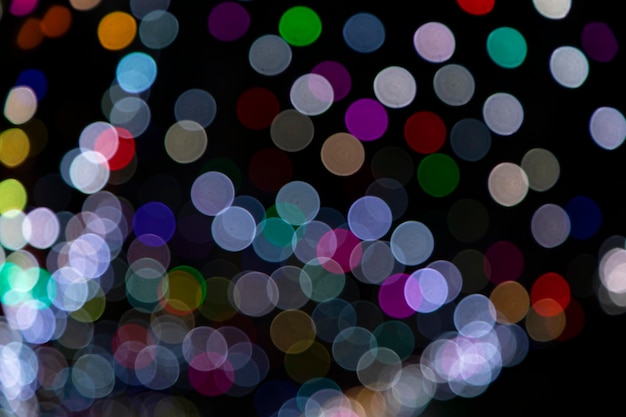 Colorido Desenfoque Resumen efectos de luz bokeh en la textura de fondo negro de la noche