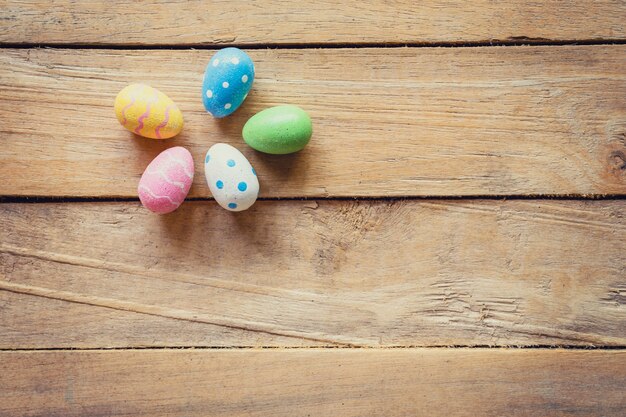 Colorido huevo de Pascua en el fondo de madera con espacio.