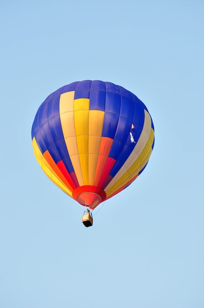 Coloridos globos aerostáticos en vuelo sobre el cielo azul