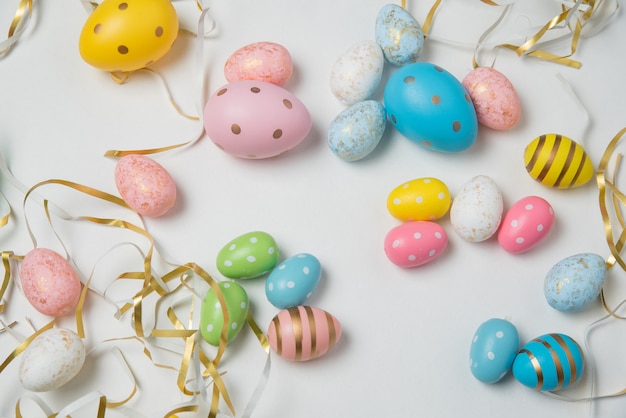 Coloridos huevos de Pascua en fondo blanco. Felices Pascuas. Vista superior