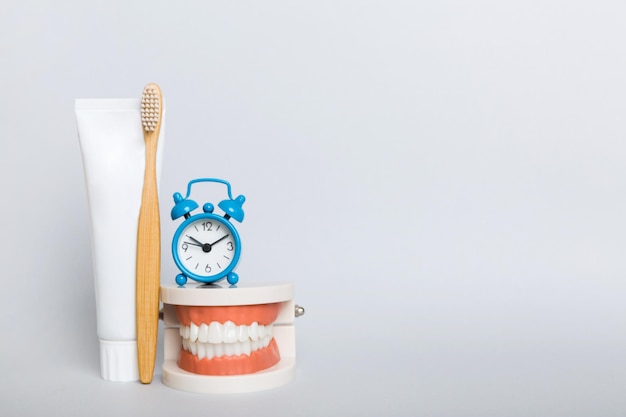 Colutório e outros produtos de higiene oral na vista de mesa colorida com espaço de cópia Postura plana Higiene dental Kit de cuidados orais Conceito de dentista