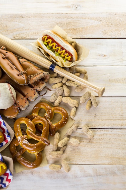 Comida de fiesta de béisbol con pelotas y guante en una mesa de madera.