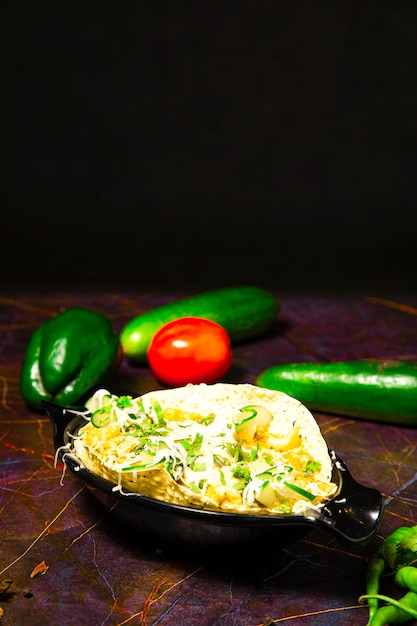 Comida indiana conhecida como Masala Papad servida como comida inicial, cobertura inclui cebola, tomate, pimentão verde