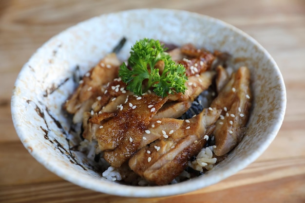 Comida japonesa, frango teriyaki com arroz em fundo de madeira