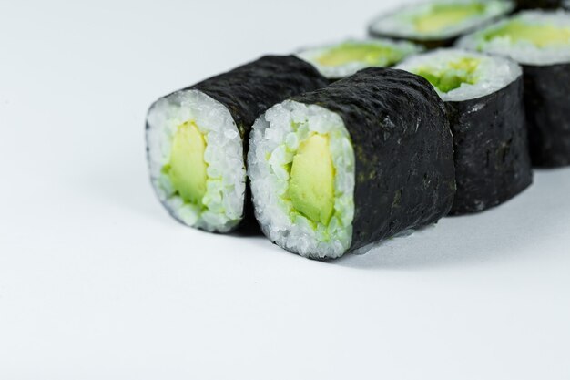 Comida japonesa. Rollos de aguacate maduro, arroz fresco con verduras al nori. Rollos vegetarianos