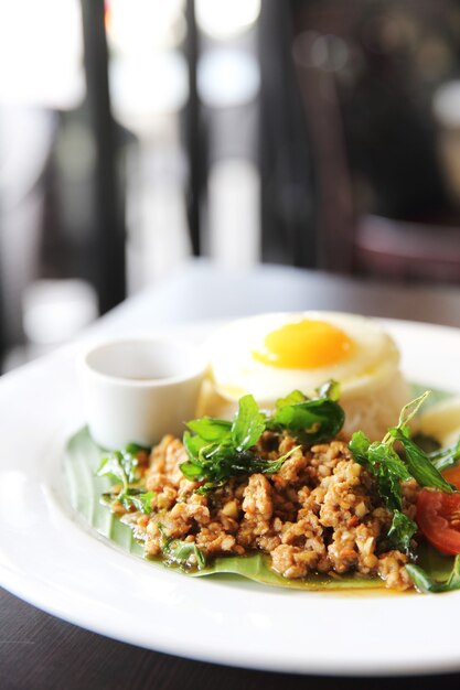 Comida tailandesa Arroz coberto com carne de porco frita e manjericão