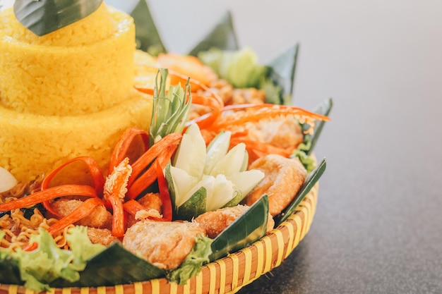 Comida tradicional de Nasi Tumpeng Nusantara Java O elaborado rijsttafel indonésio de arroz amarelo com acompanhamentos