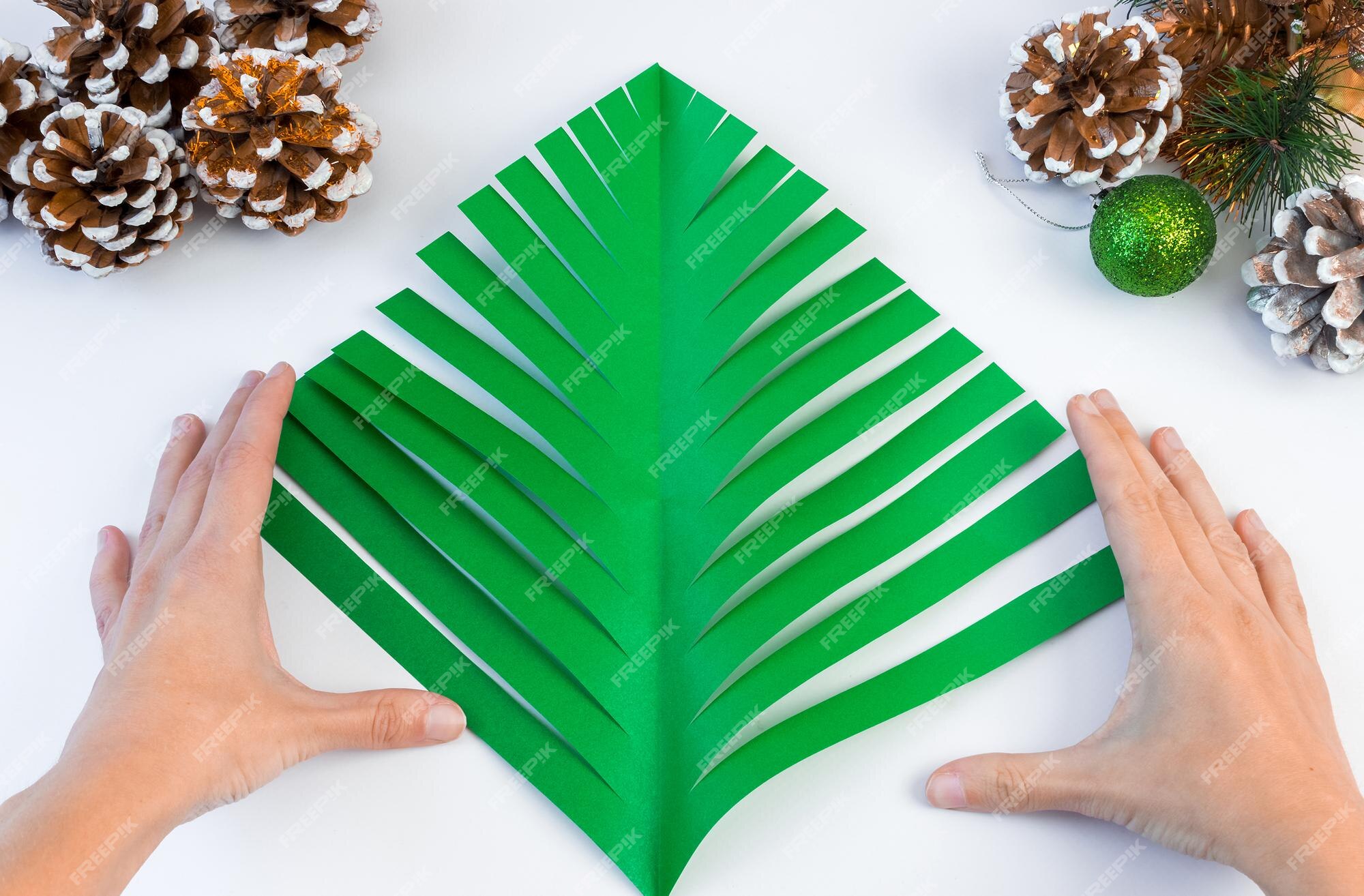Como fazer uma árvore de natal criativa com papel colorido e cola com as próprias mãos. conceito de diy. instruções passo a passo. | Foto Premium Como fazer uma árvore de natal criativa com papel colorido e cola com as próprias mãos. conceito de diy. instruções passo a passo. | Foto Premium