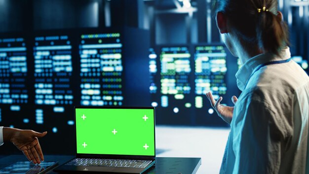 Los compañeros de trabajo usan portátiles de pantalla verde para la IA