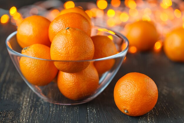 Composição de Natal com laranjas e abeto, sobre fundo de madeira