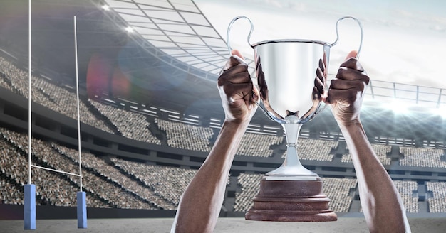 Composição do jogador de rúgbi celebrando a vitória, segurando o troféu no estádio