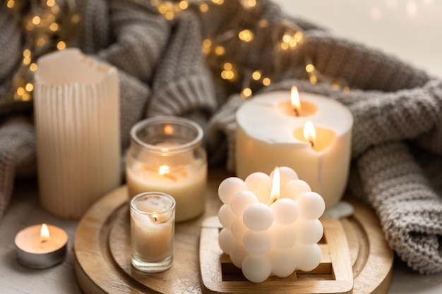 Foto una composición acogedora con velas un elemento tejido y una guirnalda