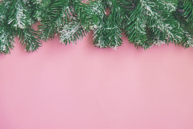 Composición con decoración navideña sobre fondo rosa para tarjeta de felicitación