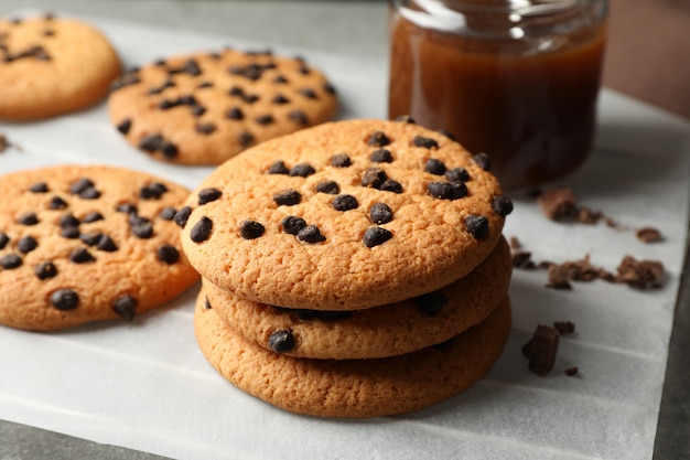 Composición con galletas chip y caramelo en mesa gris