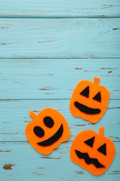 Composición de Halloween con calabazas sobre fondo de madera azul. Vista desde arriba.