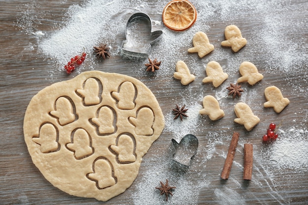 Composición con masa para galletas de Navidad en mesa de madera