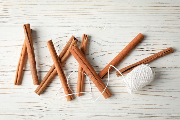 Composición con palitos de canela y cuerda en la pared de madera, espacio para texto