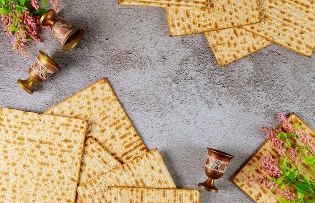 Composición con pan de matzá, copas de vino y flores. Vista superior. Fiesta judía de Pascua.