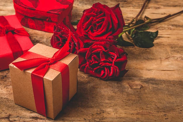 Composición de rosas rojas y cajas de regalo.