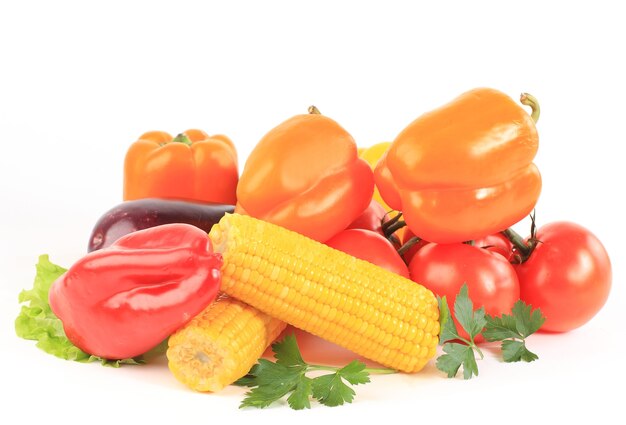 Composición con verduras crudas y cesta de mimbre aislado en blanco